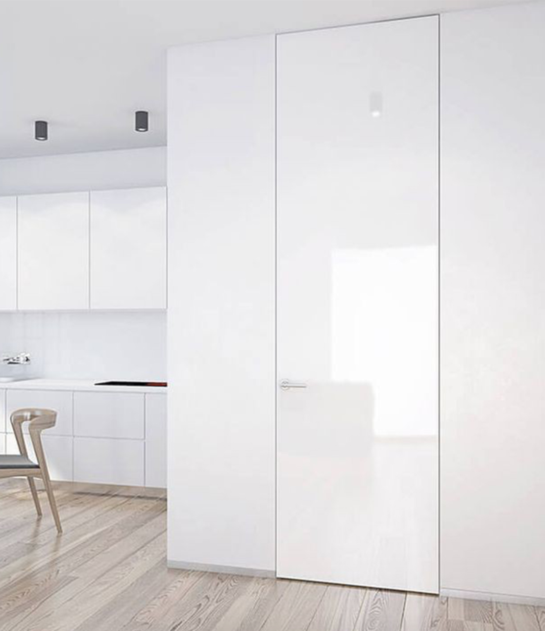 Glossy white glass concealed door blending into minimalist modern kitchen wall